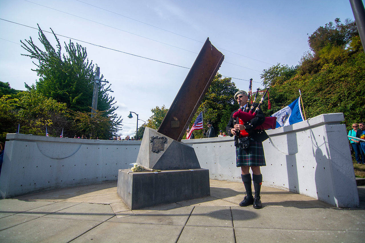 Retired Coast Guardsman Rick McKenzie plays bagpipes during a ceremony in Port Angeles honoring public safety officials on the 18th anniversary of the 9/11 terrorist attacks Wednesday. (Jesse Major/Peninsula Daily News)