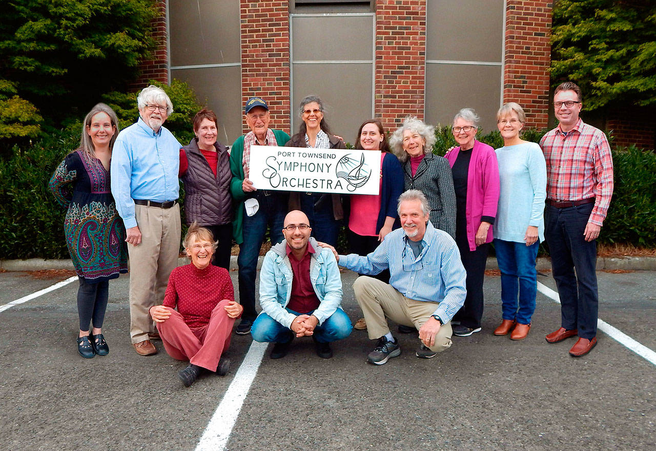 The Port Townsend Symphony Orchestra board shows off an enlarged version of the group’s new logo. Pictured in front row, from left, are Kristin Smith, Tigran Arakelyan and Robert Nathan; standing, from left, are Denise Sample, Miles Vokurka, Vicki Mansfield, Tom Berg, Lesa Barnes, Arianna Golden, Nan Toby Tyrrell, Pat Yearian, Nancy Miskimins and graphic artist James Sample.