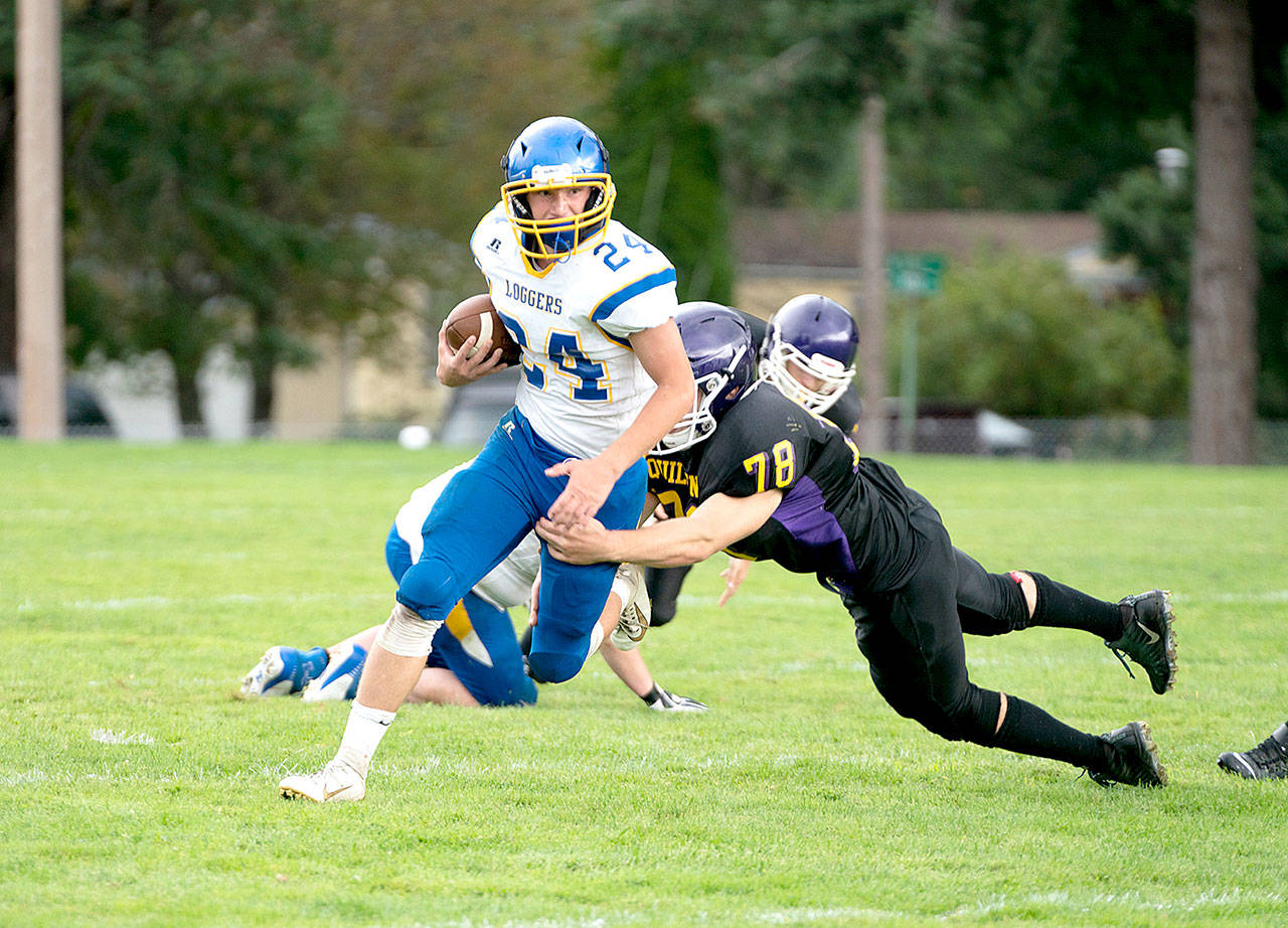 Crescent Logger Brayden Emery tries to avoid the tackle by Ranger Zach Budnek during a Saturday afternoon game against Quilcene. (Steve Mullensky/for Peninsula Daily News)