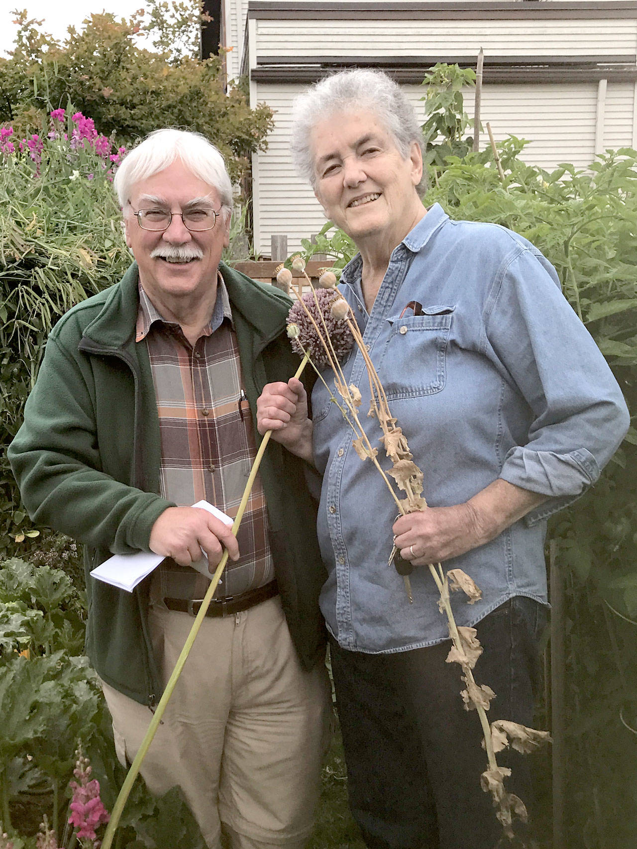 Bob Cain, left, and Muriel Nesbitt pose in the Fifth Street Community Garden in Port Angeles, where a variety of non-hybrid seeds are sown. (Betty Harriman)