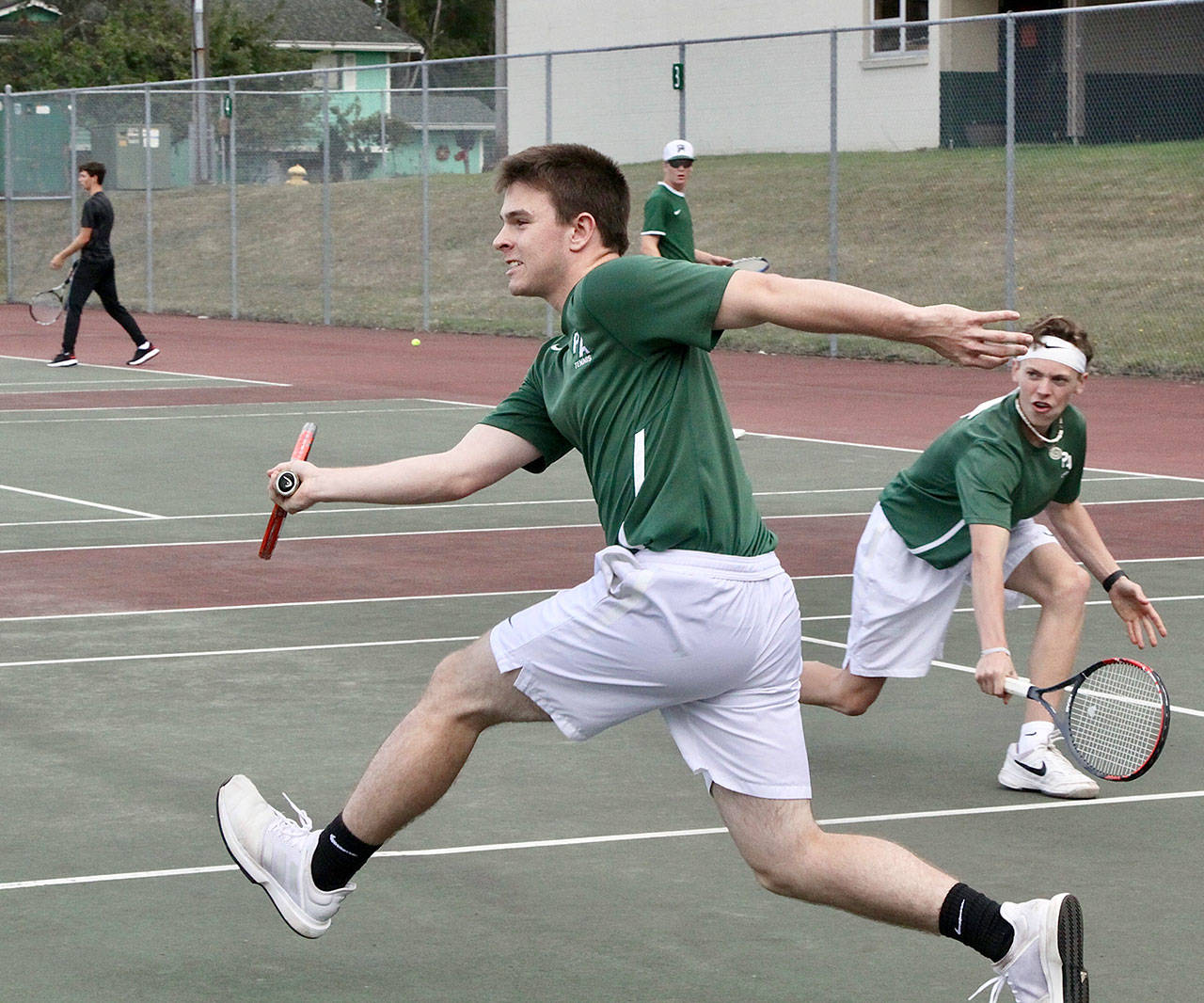 Dave Logan/for Peninsula Daily News The Port Angeles boys tennis doubles duo of Milo Whitman, front, and Dru Clark competed in a rain-shortened match against Klahowya on Monday.