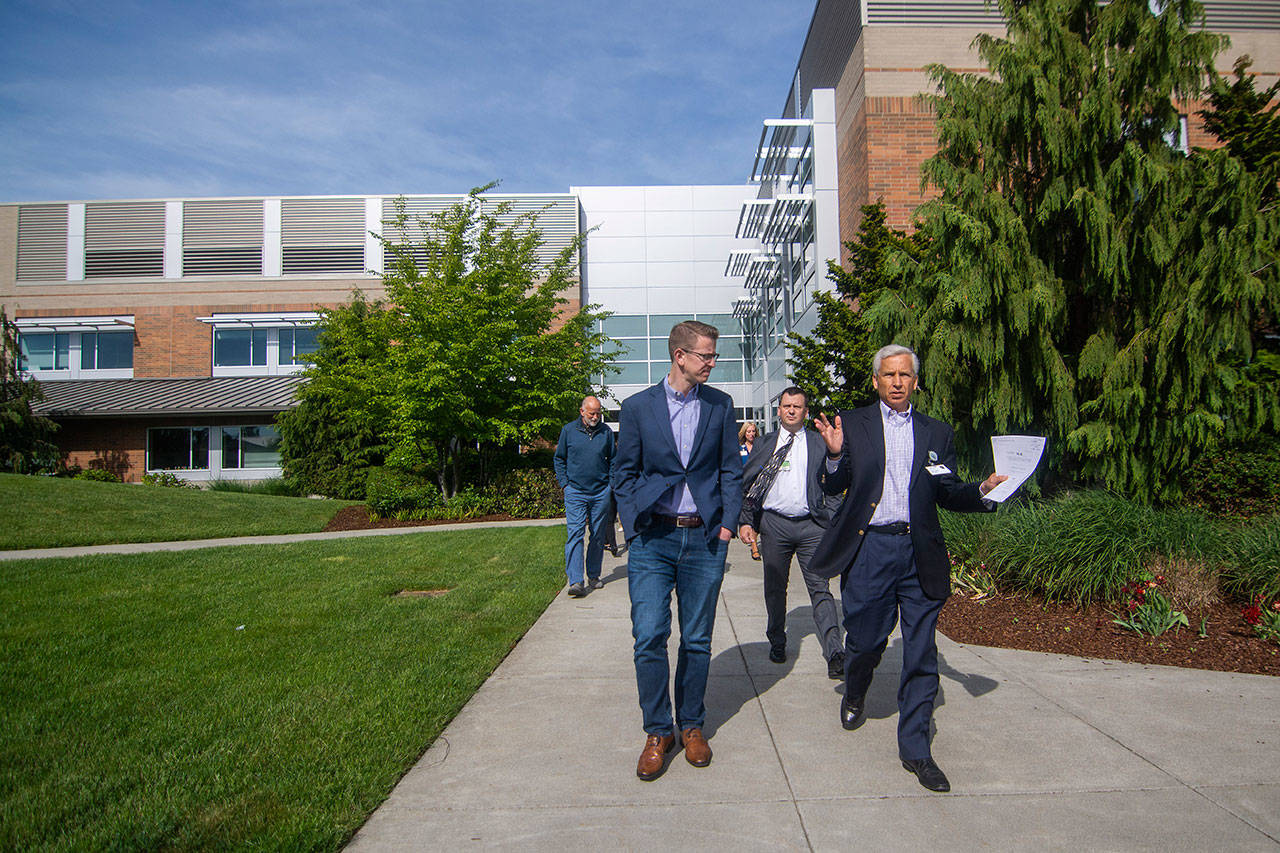 U.S. Rep. Derek Kilmer, left, and Olympic Medical Center CEO Eric Lewis walk through OMC’s Sequim Campus in May. (Jesse Major/Peninsula Daily News)