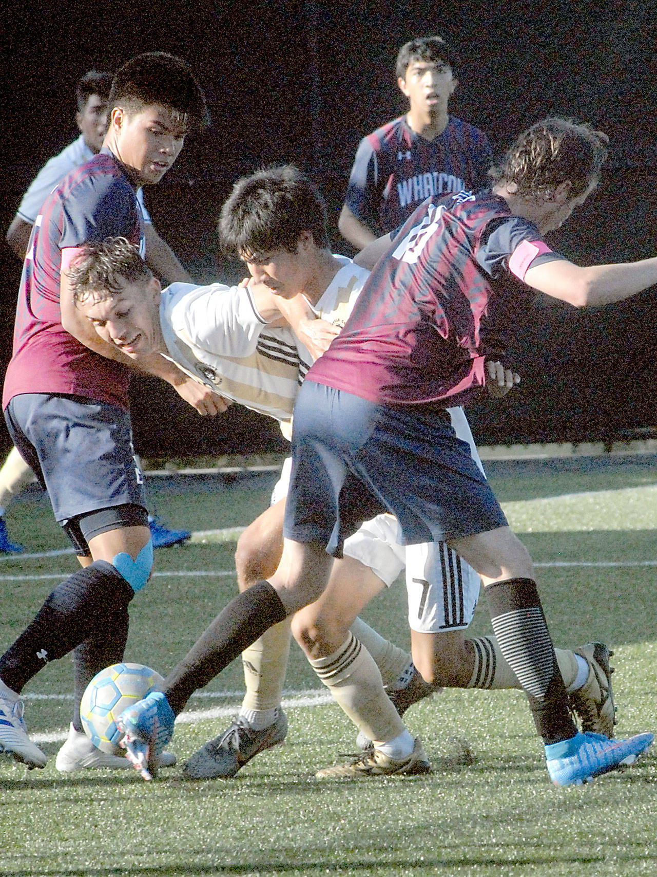 Keith Thorpe/Peninsula Daily News Peninsula’s Mason Haubrich, center left and Hide Inoue, center right, try to burst through the defense of Whatcom’s Pono Halemano, left and Clover Martin during Wednesday’s match at Wally Sigmar Field in Port Angeles.
