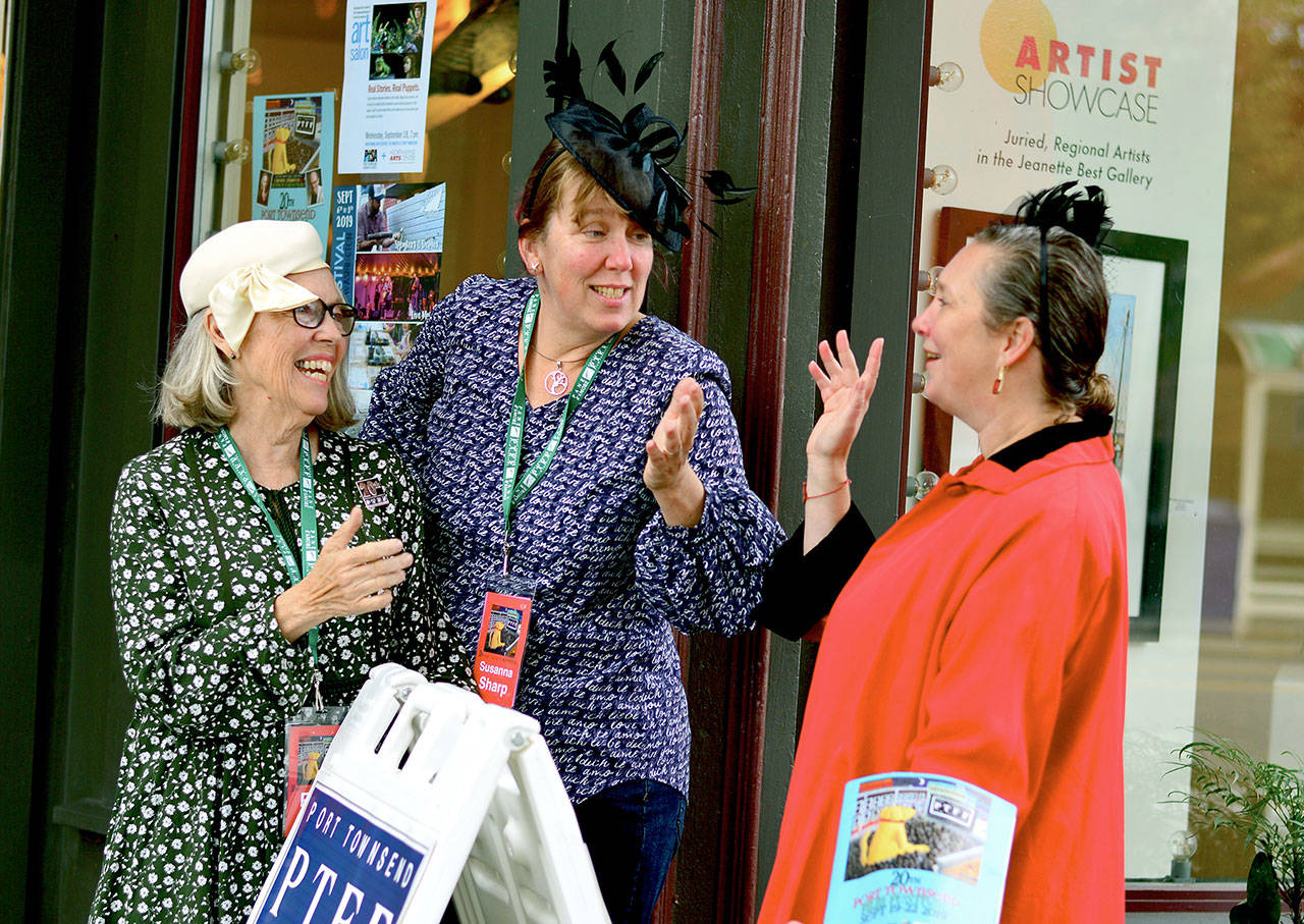Concierges Pam Gould, left, and Susanna Sharp station themselves with maitre d’hotel Amanda Steurer-Zamora, right, at the Port Townsend Film Festival’s Northwind Arts Center hospitality suite Thursday morning. (Diane Urbani de la Paz/for Peninsula Daily News)