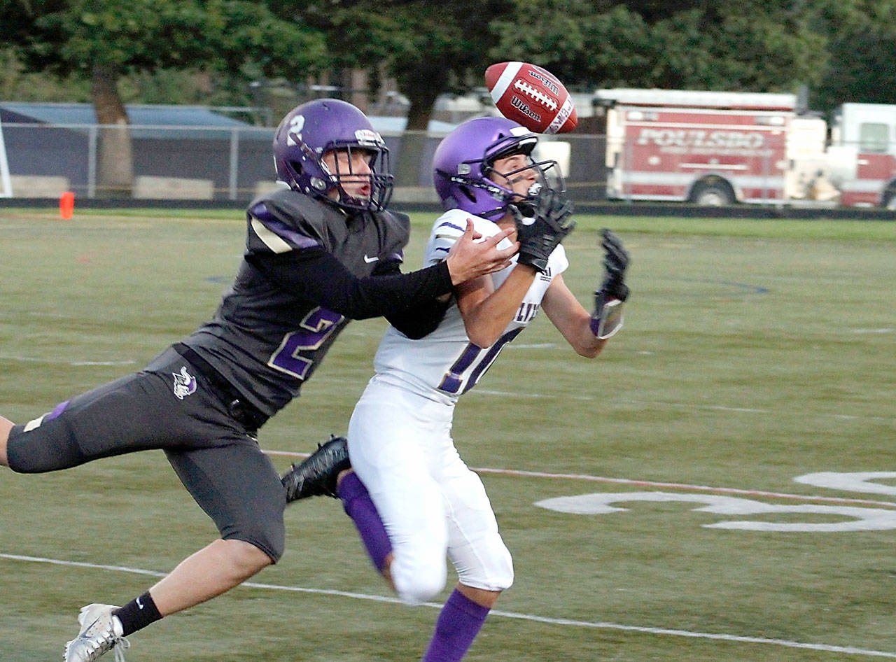 Garrett Hoesel tries to haul in a pass while holding off North Kitsap’s Colton Bower. (Mark Krulish/Kitsap News Group)