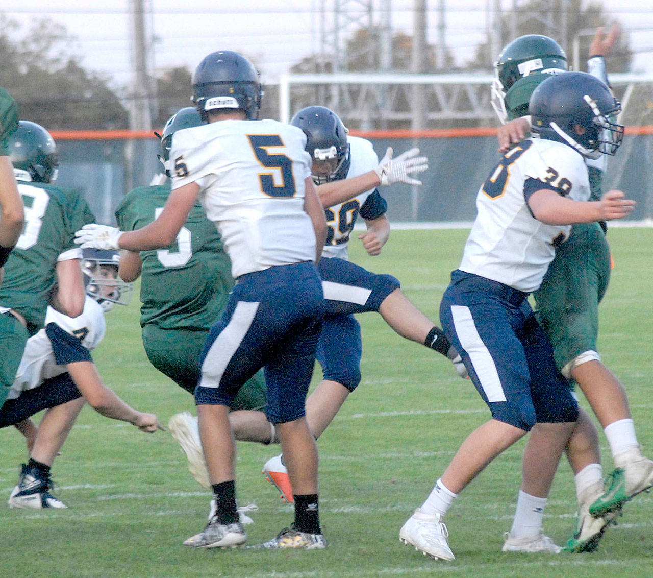 Forks placekicker Ethan Bello, center, boots a 35-yard field goal during a game against Port Angeles earlier this month. Bello went 4 for 4 on field goals and 4 of 5 on point-after attempts during Forks’ 46-20 win over Port Townsend last Friday. (Keith Thorpe/Peninsula Daily News)