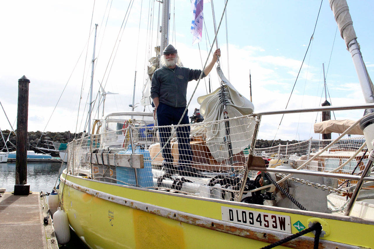 Olivier Huin stands Thursday aboard the 51-foot sailboat Breskell that he built in the 1980s at the Port Townsend Boat Haven Marina after completing a trip through the Northwest Passage and returning home to Jefferson County. (Zach Jablonski/Peninsula Daily News)
