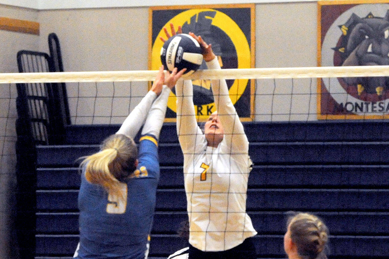 Lonnie Archibald/for Peninsula Daily News Forks’ Kyra Neel, right, blocks Rochester’s Kortney Kerbaugh during this nonleague contest with the Warriors in Forks. Rochester won the match in four close sets 25-22, 22-25, 25-23, 25-18.