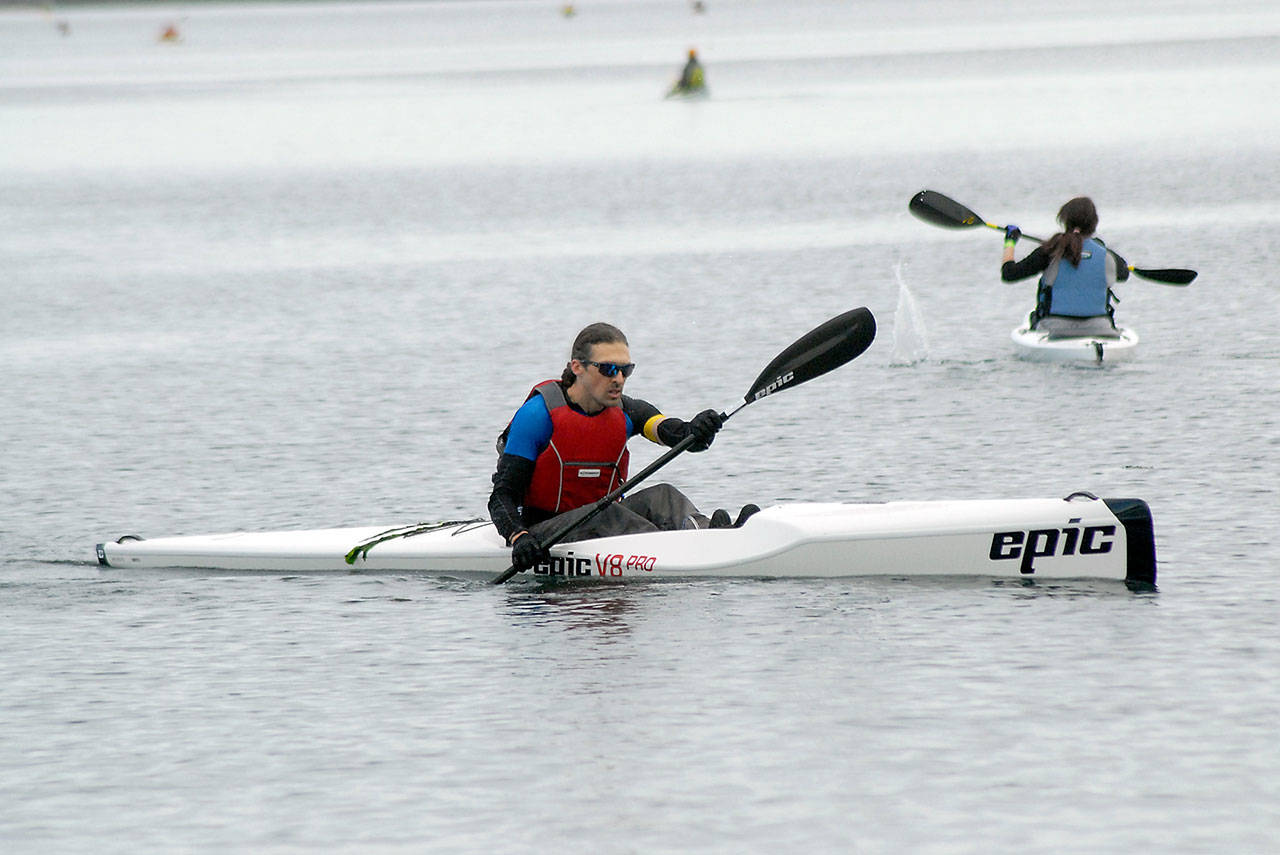 <strong>Keith Thorpe</strong>/Peninsula Daily News                                Troy Treaccar, owner of Sound Bikes & Kayaks of Port Angeles, a competetor in the iron category, paddles to the finish of the kayak leg of Saturdays Big Hurt race in Port Angeles. The event featured teams and individuals taking part in a race of mountain bikes, kayaks, road bicycles and feet.
