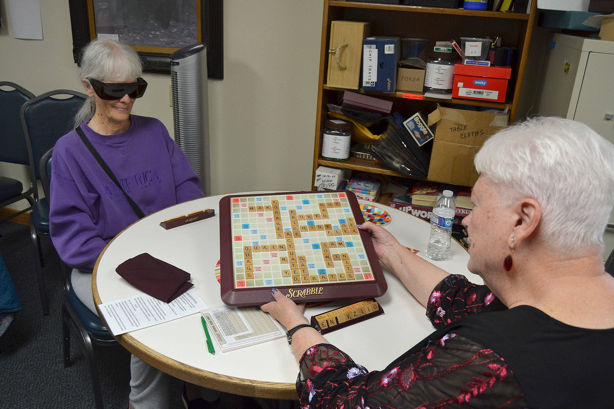 Bobbie Dahn shows her “bingo” in a game of Scrabble against Marilyn Van Patter where she opened the game with the word “actuate” using all seven of her tiles earning 50 additional points. Dahn has led Scrabble for 17 years at Shipley Center. Matthew Nash/Olympic Peninsula News Group