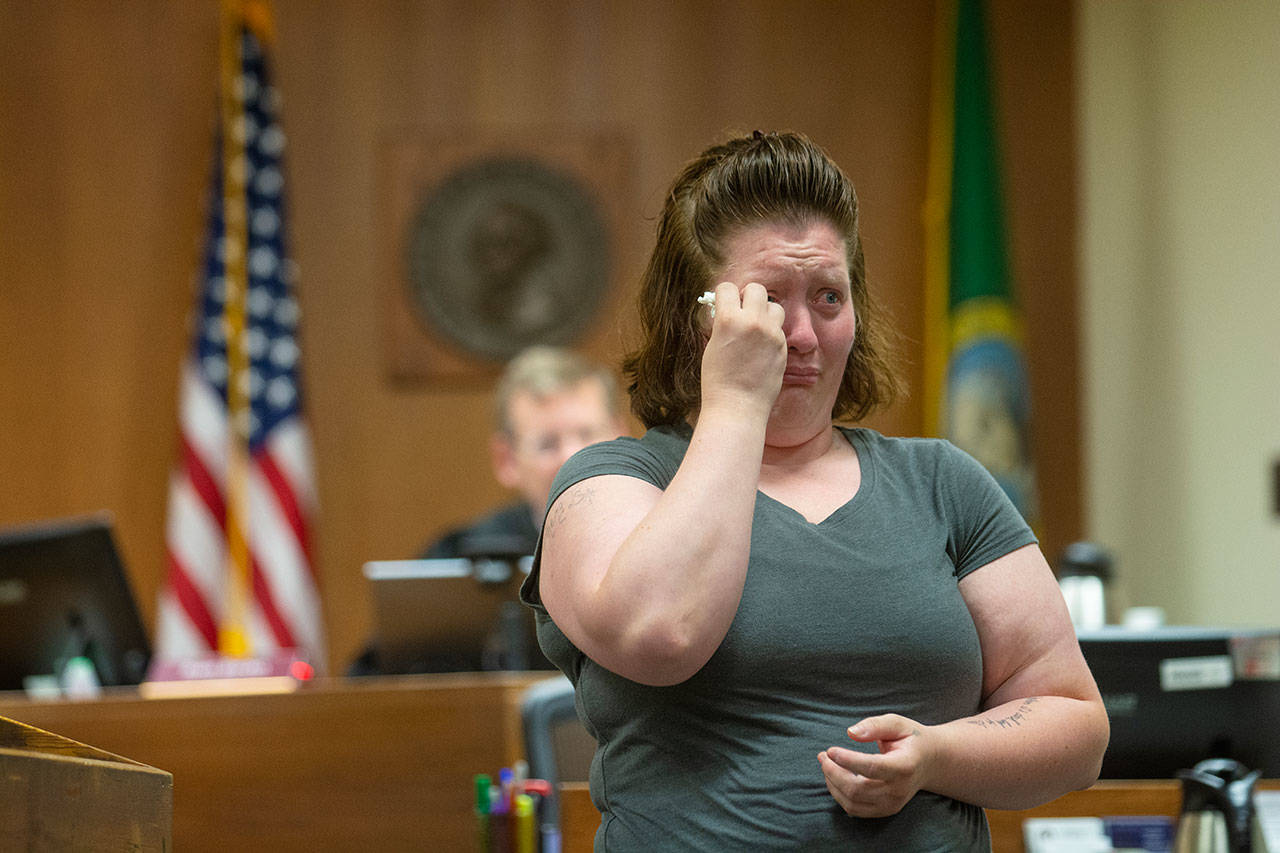 Sandra “Tina” Schroeder of Port Angeles wipes tears from her eyes as she graduates from drug court. (Jesse Major/Peninsula Daily News)