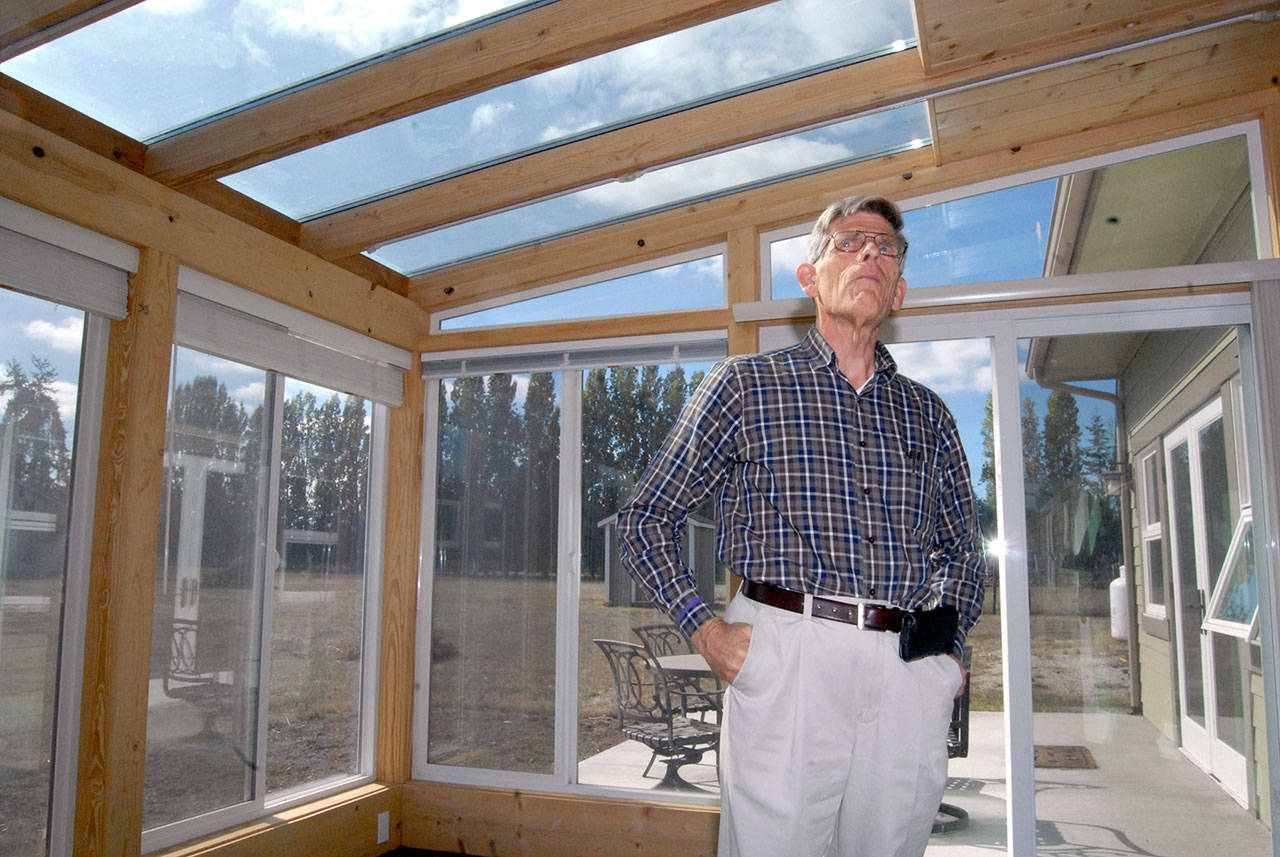 A sunroom with triple-pane windows and heat-absorbing tiles provides a large portion of the heat in David Large’s rural Sequim home, seen here in September 2018. (Keith Thorpe/Peninsula Daily News)
