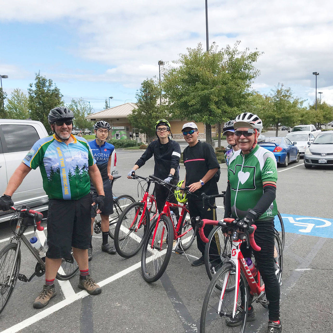 Toshihiro Kamei of the Shiso Board of Education (third from left) and Takashi Asada, principal of Haga Junior High School (fourth from left), take a bicycle tour last week with Sequim locals, a group that included, from left, Dave Toman, Liam Barber, Rebecca Tenzyhoff and Bob Annunson. Submitted photo