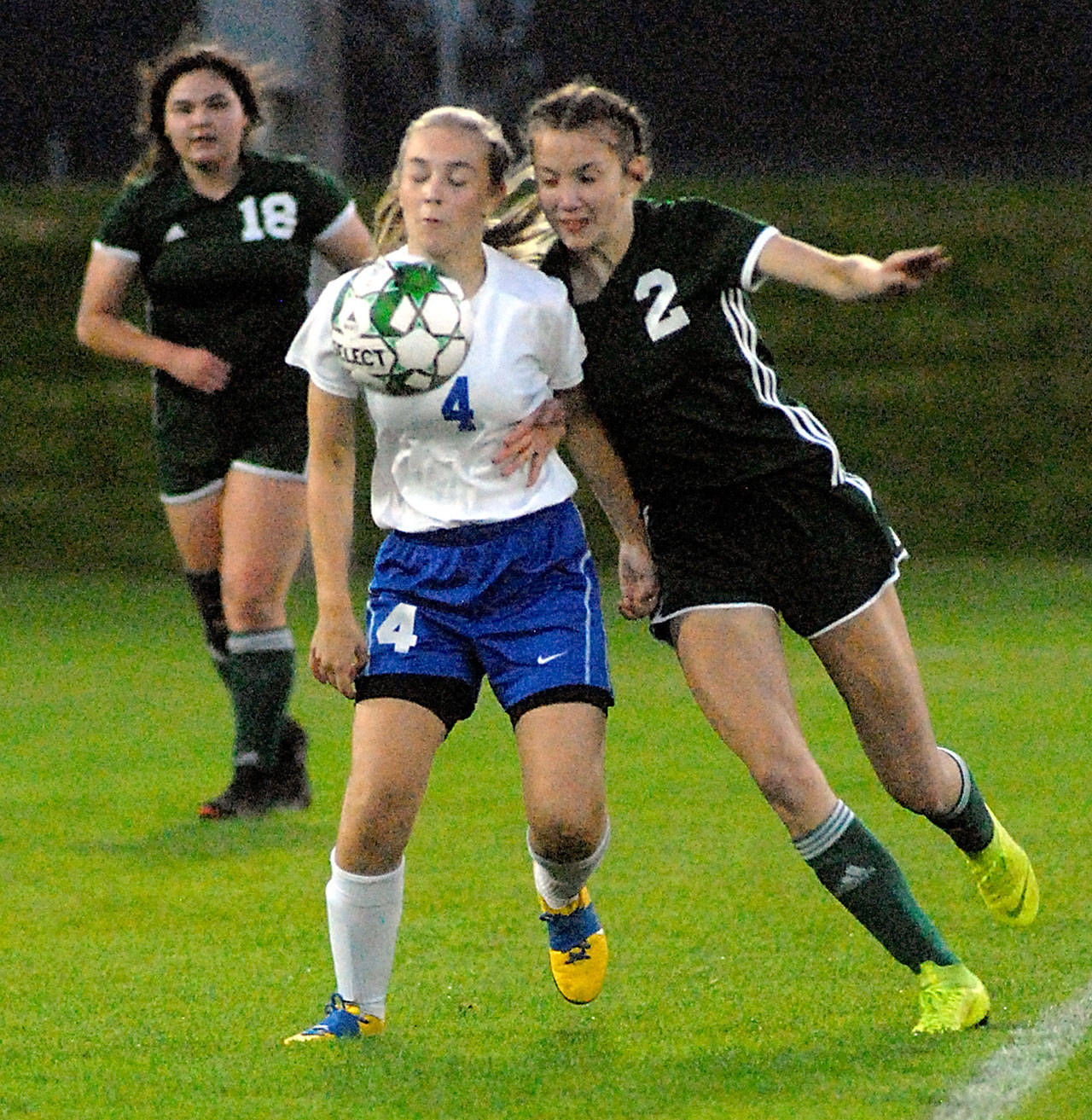 Reese Flanagan of Bremerton, center, and Port Angeles Catherine Brown, right, jostle along the sidelines as browns teammate, Kiana Watson-Charles, left, watches from behind on Tuesday night in Port Angeles. (Keith Thorpe/Peninsula Daily News)