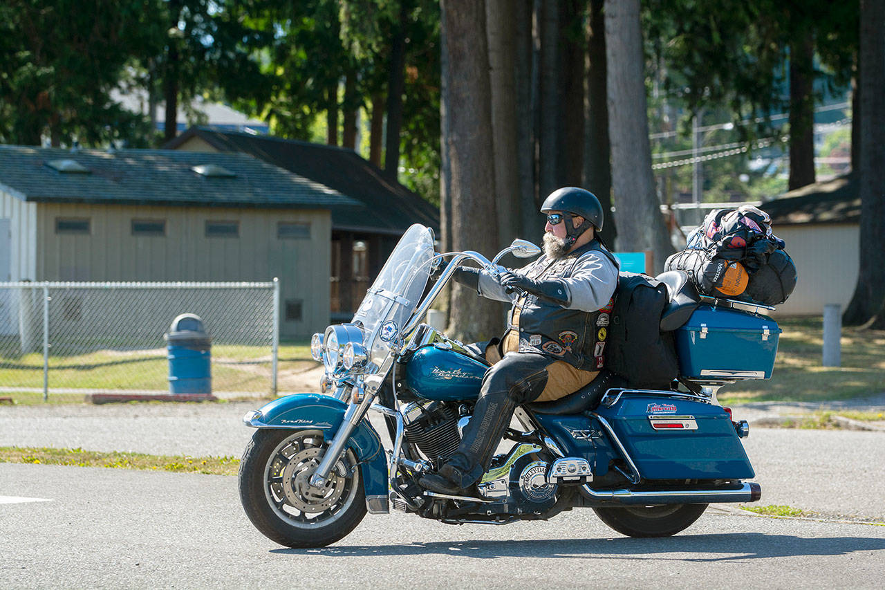 Bob Glaves of Alaska is pictured riding his motorcycle in Port Angeles on the day he left for Washington, D.C., on July 21. (Jesse Major/Peninsula Daily News)
