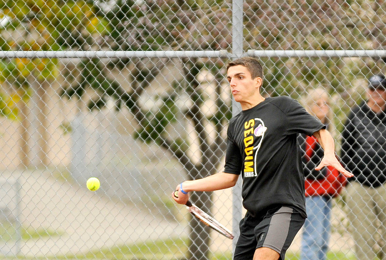 Michael Dashiell/Olympic Peninsula News Group Sequim’s Nico Zingaro returns a volley against Port Angeles’ Reef Gelder on Wednesday. Zingaro won his match as the Wolves gave the first-place Riders everything they could handle in Sequim.
