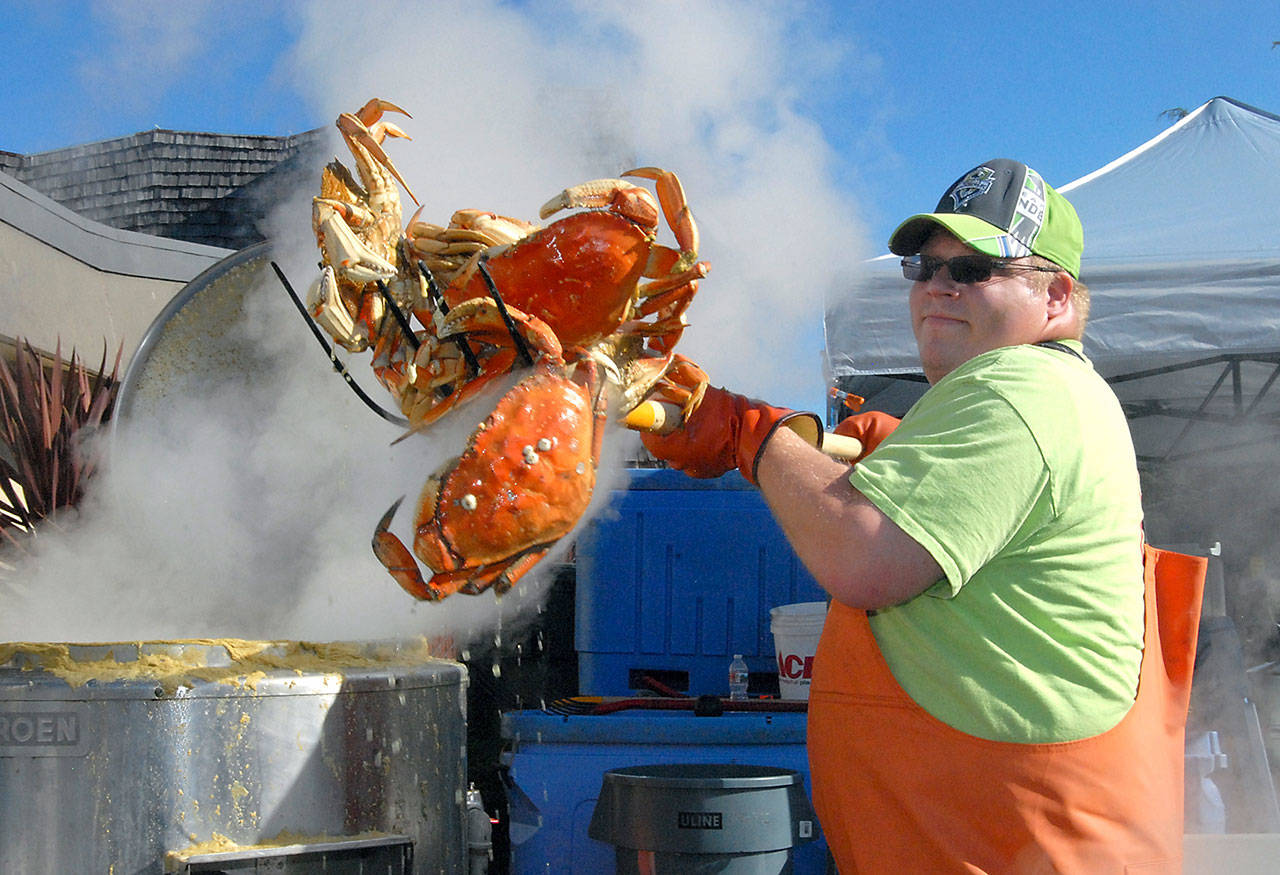 Crab cook Jacob Brown of Port Angeles pulls whole crabs from a boiler in preparation for the 2018 Dungeness Crab & Seafood Festival in downtown Port Angeles. (Keith Thorpe/Peninsula Daily News)