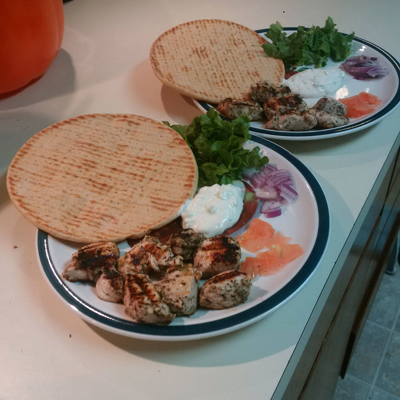 Pitas, lettuce, red onion, tomato, homemade Greek chicken and homemade tzatziki sauce await hungry stomachs. (Emily Hanson/Peninsula Daily News)