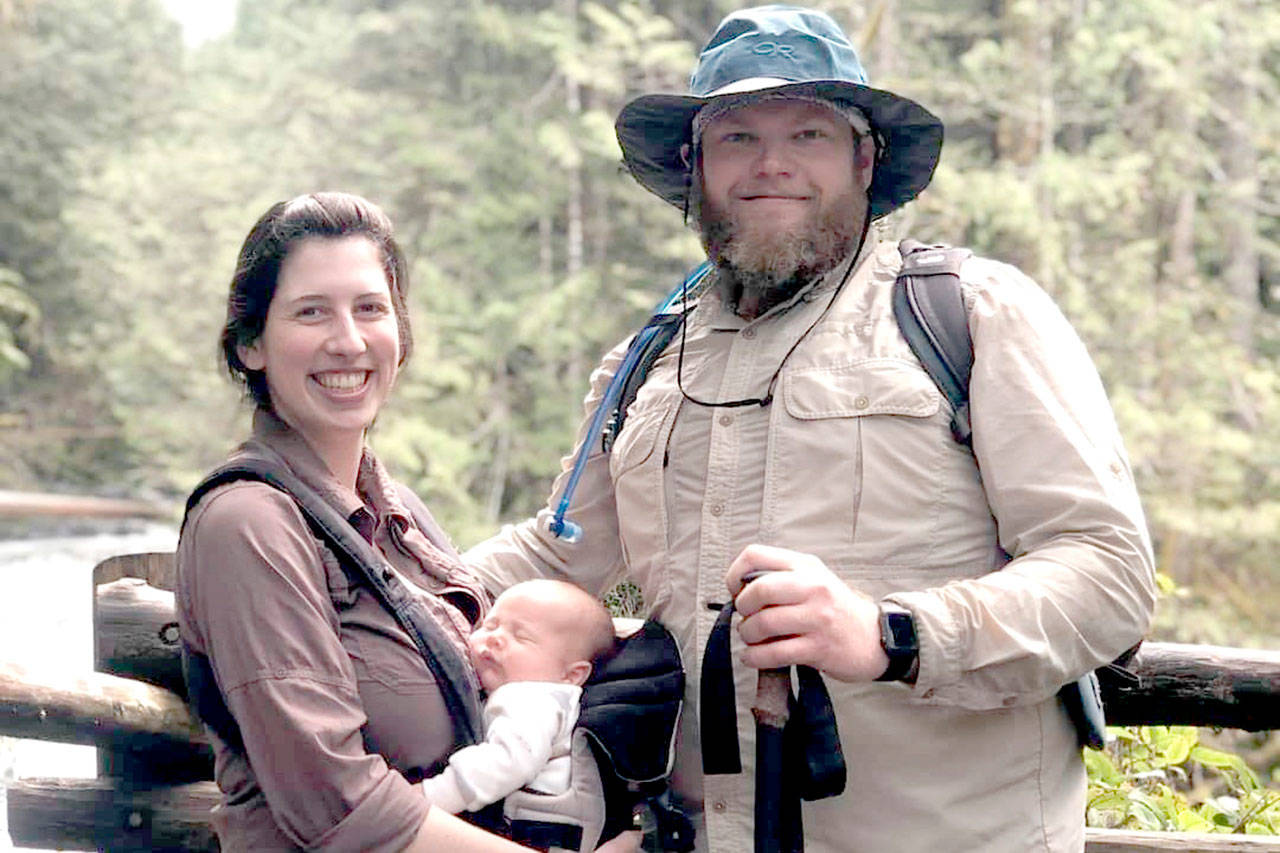 Caitlin Ford stands with Aaron Brengle as she holds their son, Liam, who is now 6 months old, in this photo taken this summer. Brengle fell in Olympic National Park while the couple was hiking near Lake Constance in September, and remains at Harborview Medical Center in Seattle after he was airlifted by a team from Naval Air Station Whidbey Island. (GoFundMe)