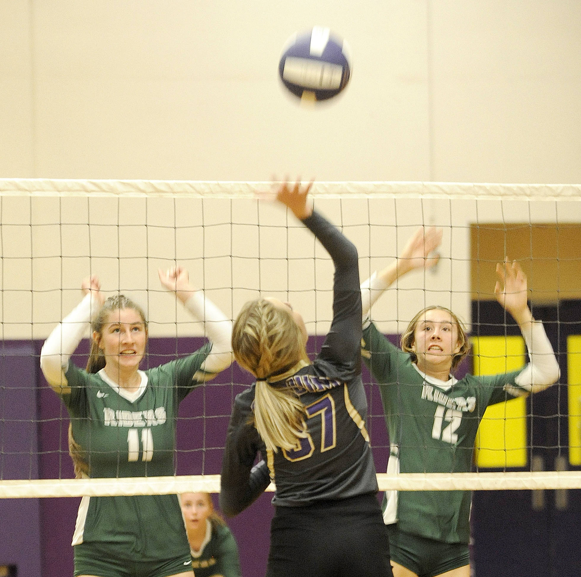 <strong>Michael Dashiell</strong>/Olympic Peninsula News Group                                Port Angeles’ Ava Brenkman, left, and Zoe Smithson look to block a hit by Liz Daigle in the second game of the teams’ five-game thriller Tuesday night.