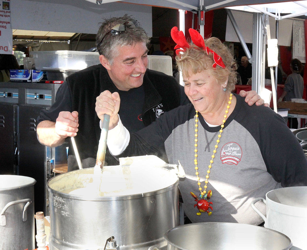Dave Logan/For Peninsula Daily News Diana Losch, right, volunteers at CrabFest one last time, stirring a pot with friend Toga Hertzog.