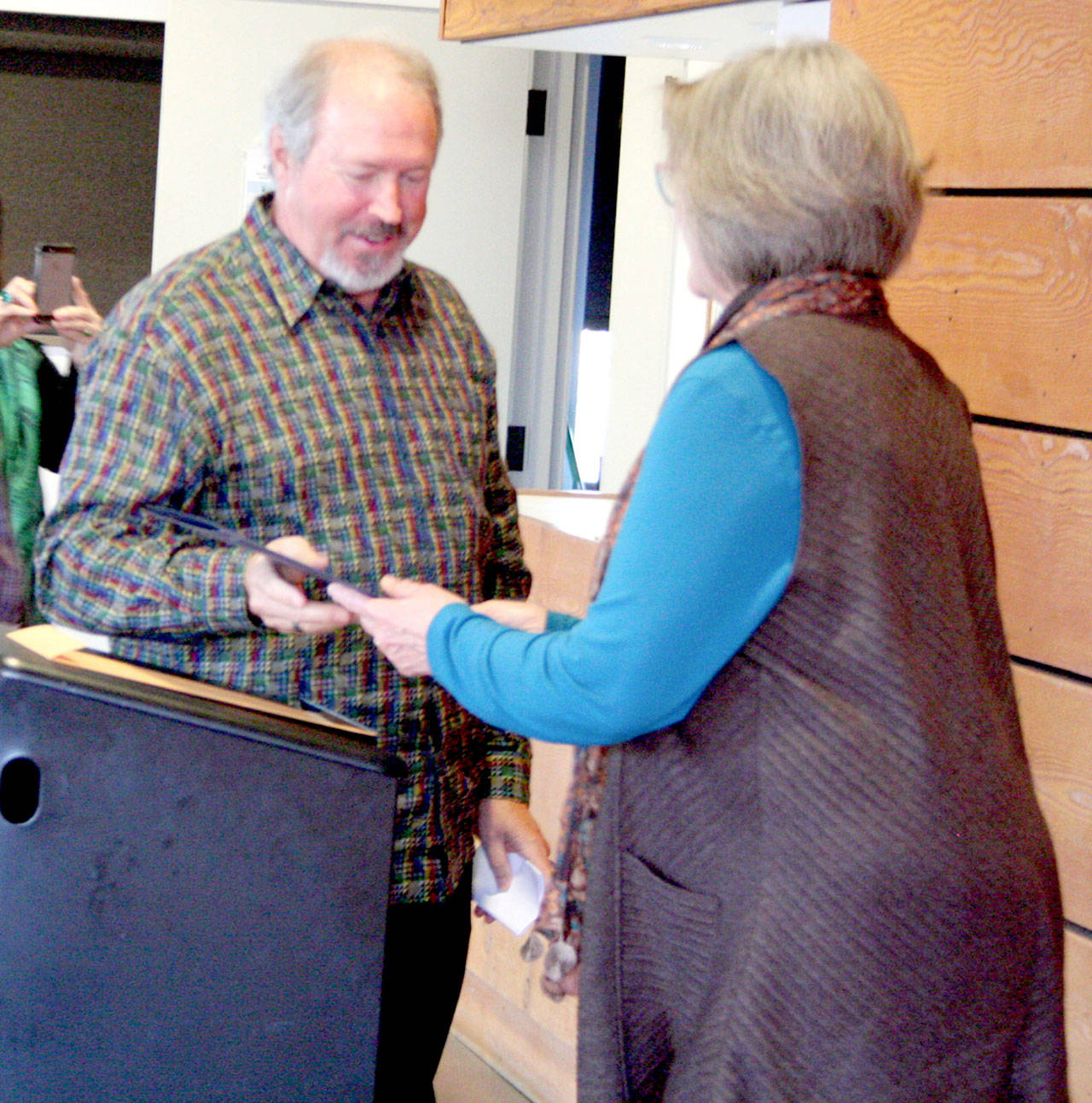 Stephen Yates, left, accepts a city proclamation declaring him the Arts Commission’s Angel of the Arts from Mayor Deborah Stinson during a ceremony Friday at the Cotton Building downtown Port Townsend. (Brian McLean/Peninsula Daily News)