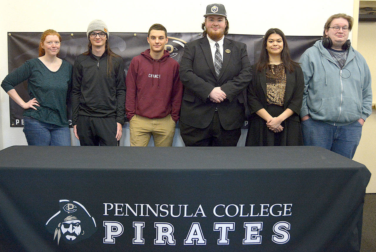 From left, Peninsula College esports coach Charlie Morrow stands with Overwatch team members Cameron Fouts, Levi Foy, Mike Roggenbuck, Ashley Frantz and Ted Cosmez. Not pictured are team members Katelyn Simmons and Damien Cundiff. (Submitted photo)