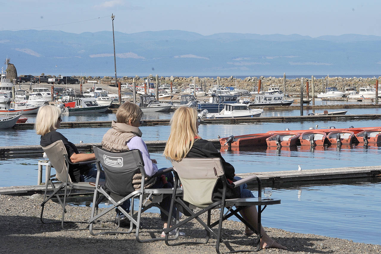 Visitors take in the view of the Van Riper’s Resort moorage docks in Sekiu. (Lonnie Archibald/for Peninsula Daily News)