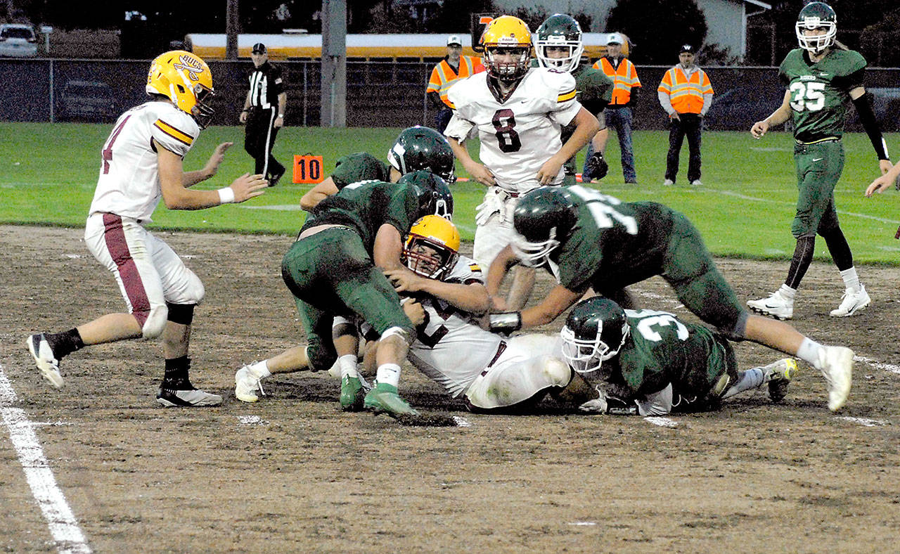 Port Angeles football players tackle a Kingston ball carrier on the Civic Field infield during a game earlier this season at Civic Field. (Keith Thorpe/Peninsula Daily News)