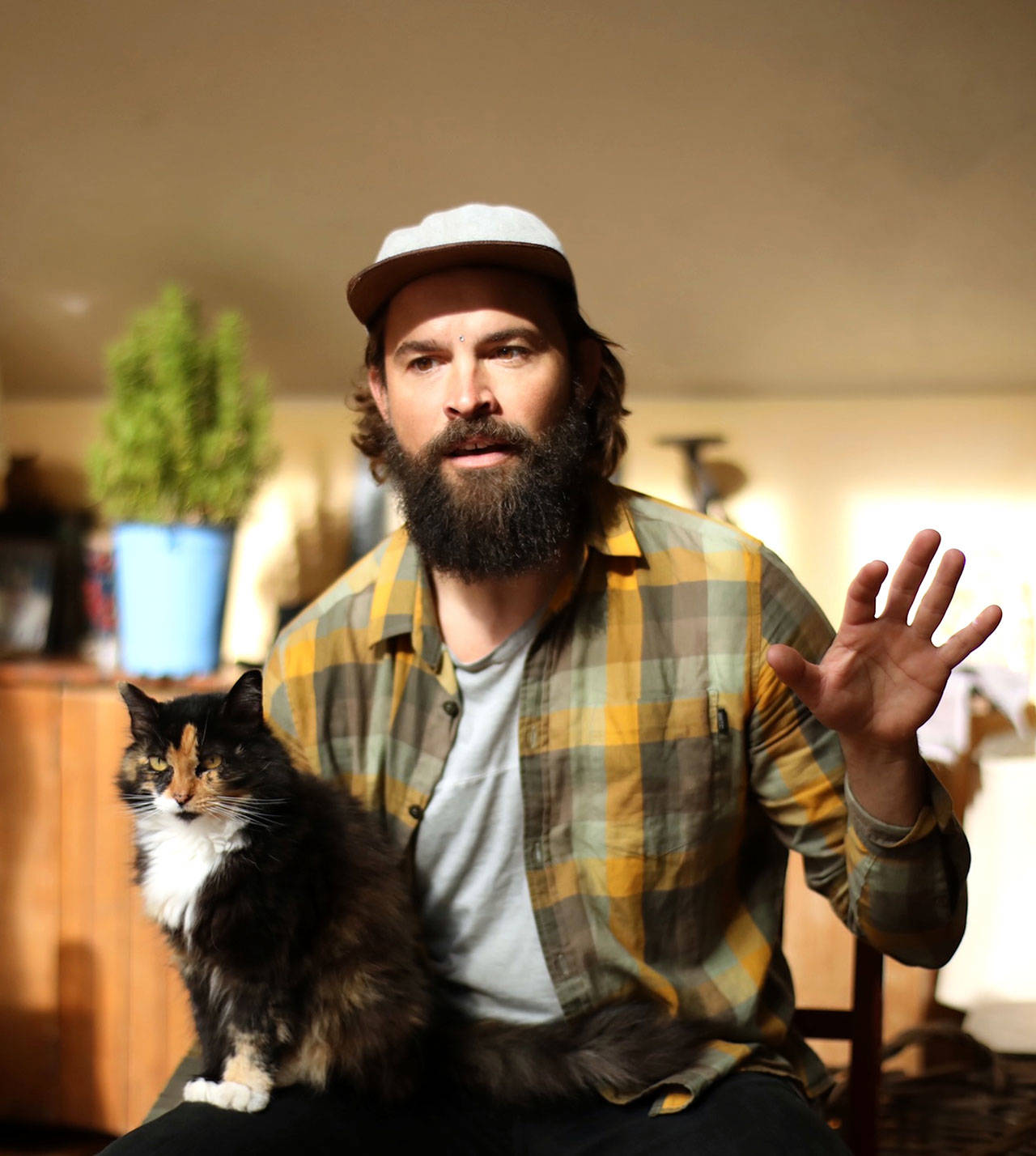 Actor Dillon Porter rehearses for ‘Walt Whitman 200,’ his production starting Thursday at Port Townsend’s Chameleon Theater. Spice the cat provided criticism. (Dillon Porter)