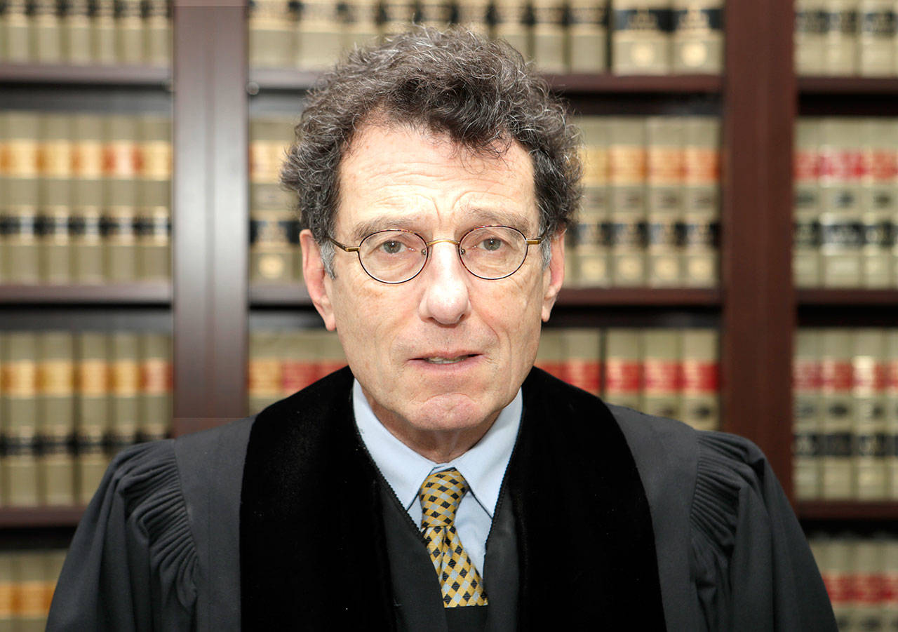 This 2018 photo shows U.S. District Court Judge Dan Polster in his office in Cleveland. (AP Photo/Tony Dejak, File)