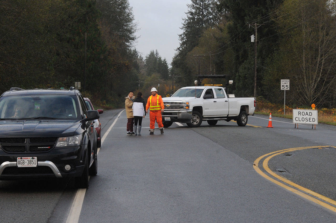 A roadblock was in place Tuesday morning at U.S. Highway 101 and Russell Road in Forks after a semitruck pulling a propane tank-trailer overturned south of the city Monday night. (Lonnie Archibald/for Peninsula Daily News)