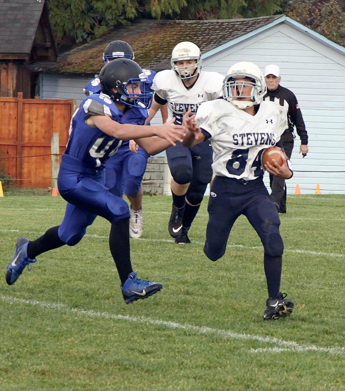 Phoenix Flores of the Stevens Middle School Stampeders, right, tries to avoid a Poulsbo Panthers defender during Stevens’ 38-0 loss to undefeated Poulsbo on Wednesday. (Dave Logan/for Peninsula Daily News)