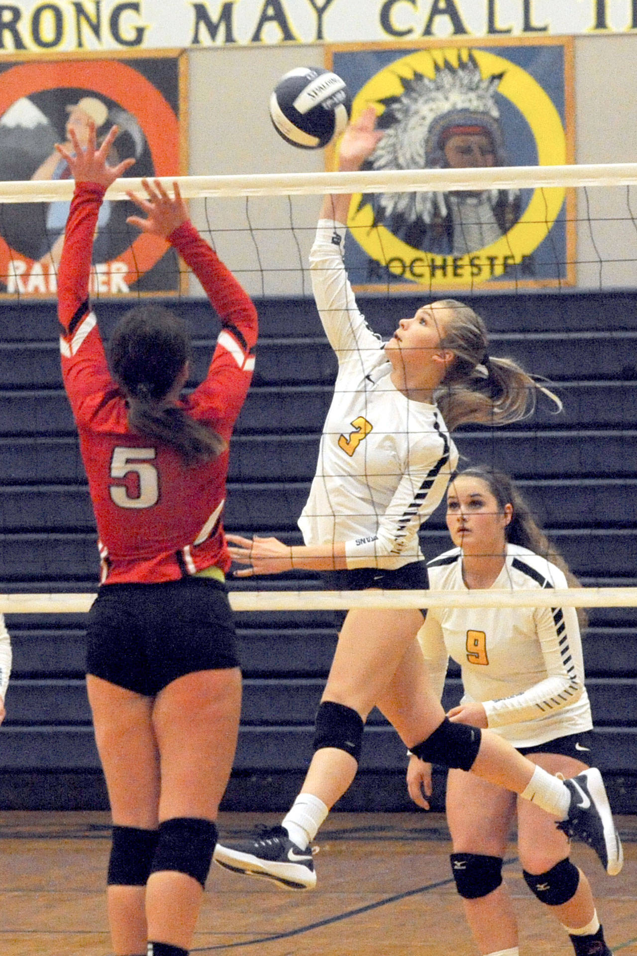 Forks’ Jayden Olson (3) hits against Tenino’s Destiny Neifert (5) during an Evergreen 1A League contest in Forks. Looking on is Forks’ Rian Peters (9). The Spartans defeated the Beavers 25-17, 25-7 and 25-10. (Lonnie Archibald/for Peninsula Daily News)