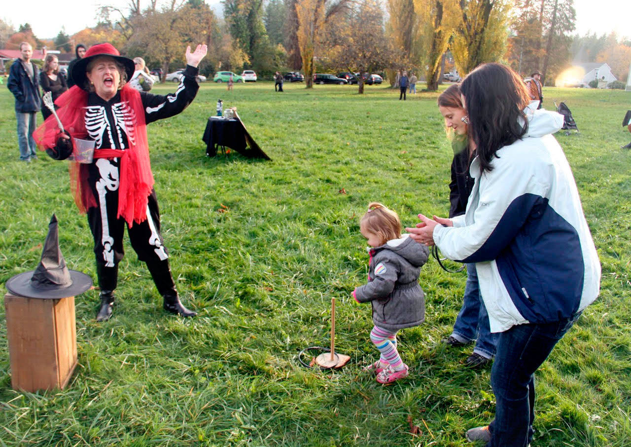 Long-time Worthington Park volunteer Carol Christiansen, dressed in costume, presides over the ring toss game (Eric Anderson)