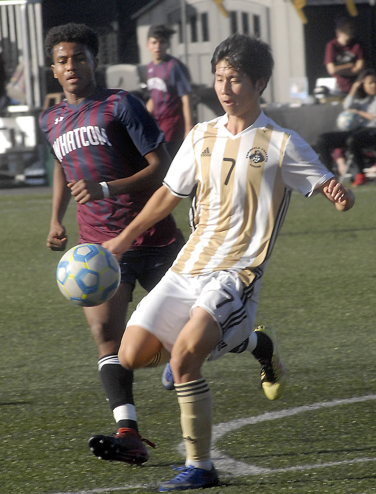 Keith Thorpe/Peninsula Daily News Peninsula’s Hide Inoue, front, keeps the ball from Whatcom’s Musab Bwana during Saturday’s match at Wally Sigmar Field in Port Angeles.