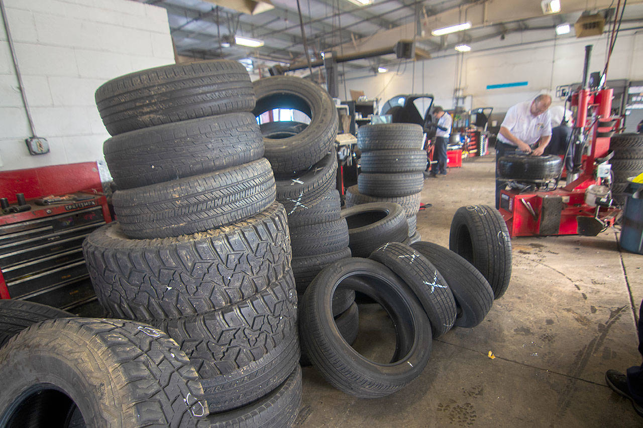 Tires punctured by screws sit at Les Schwab in Port Angeles. The State Patrol said Sunday that hundreds of screws were left on Highway 101 east of Port Angeles by accident after falling out of somebody’s vehicle. (Jesse Major/Peninsula Daily News)