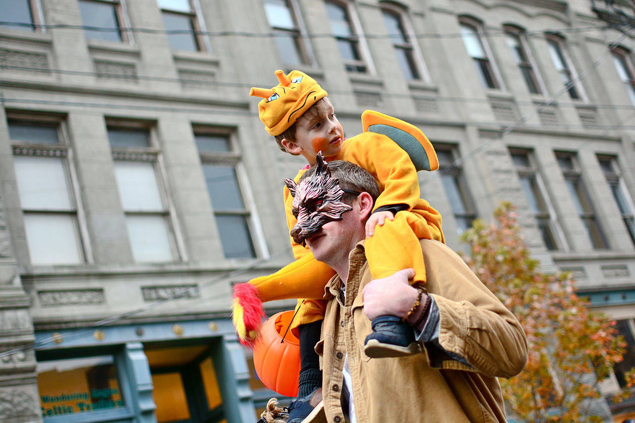 Rob Ayer carries his son Beckett Ayer during last year’s annual Main Street Downtown Trick or Treat and Costume Parade in Port Townsend. (Jesse Major/Peninsula Daily News file)