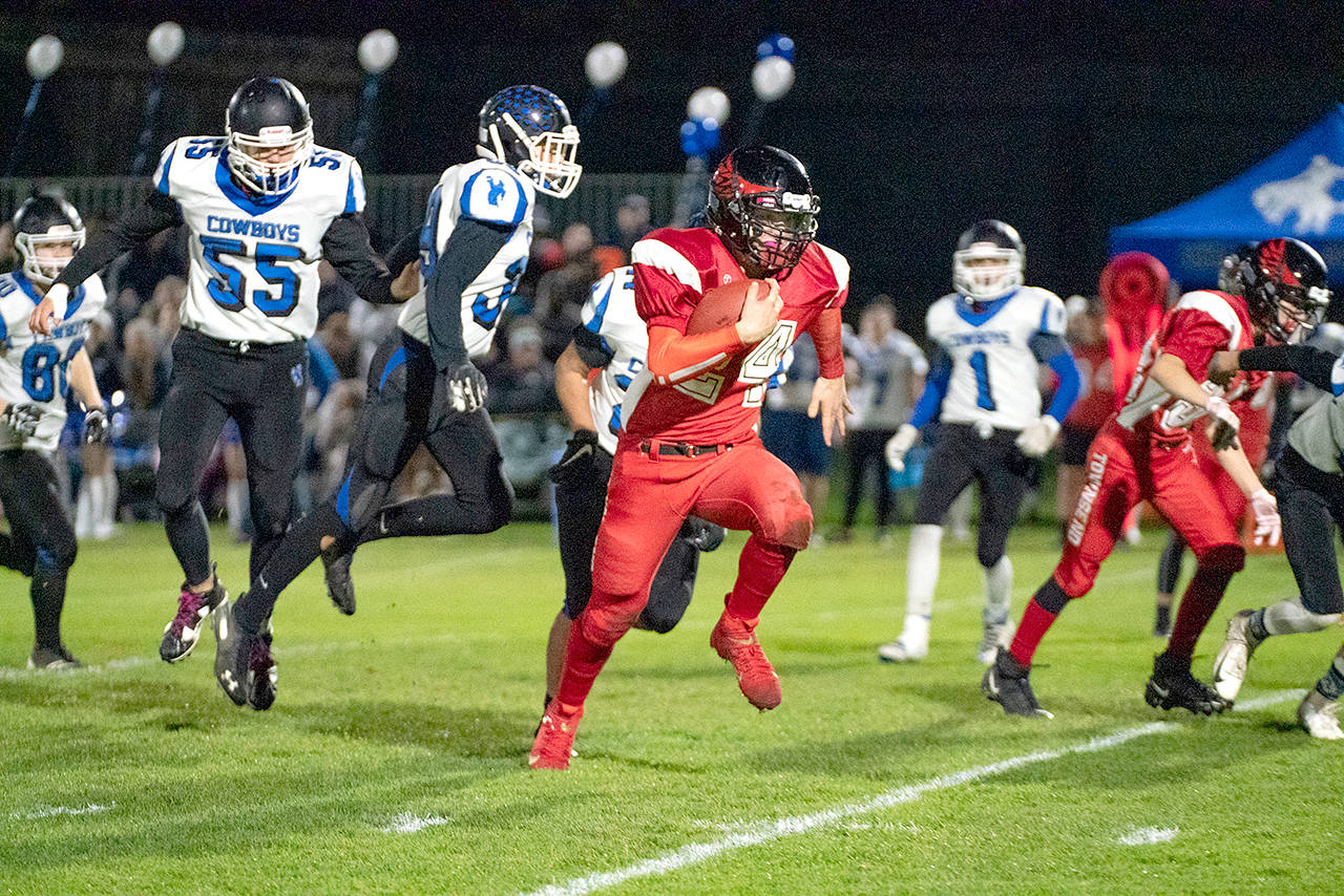 Steve Mullensky/for Peninsula Daily News Port Townsends Dylan Tracer runs against Chimacum during the Redhawks 24-22 Quimper Quarrel triumph over the Cowboys on Friday night at Memorial Field.
