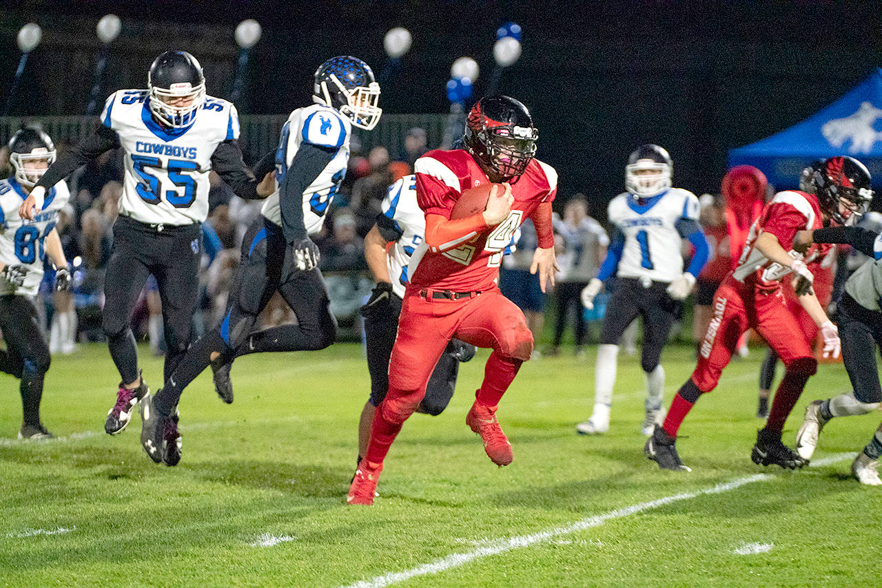 Steve Mullensky/for Peninsula Daily News Port Townsend’s Dylan Tracer runs against Chimacum during the Redhawks’ 24-22 Quimper Quarrel triumph over the Cowboys on Friday night at Memorial Field.