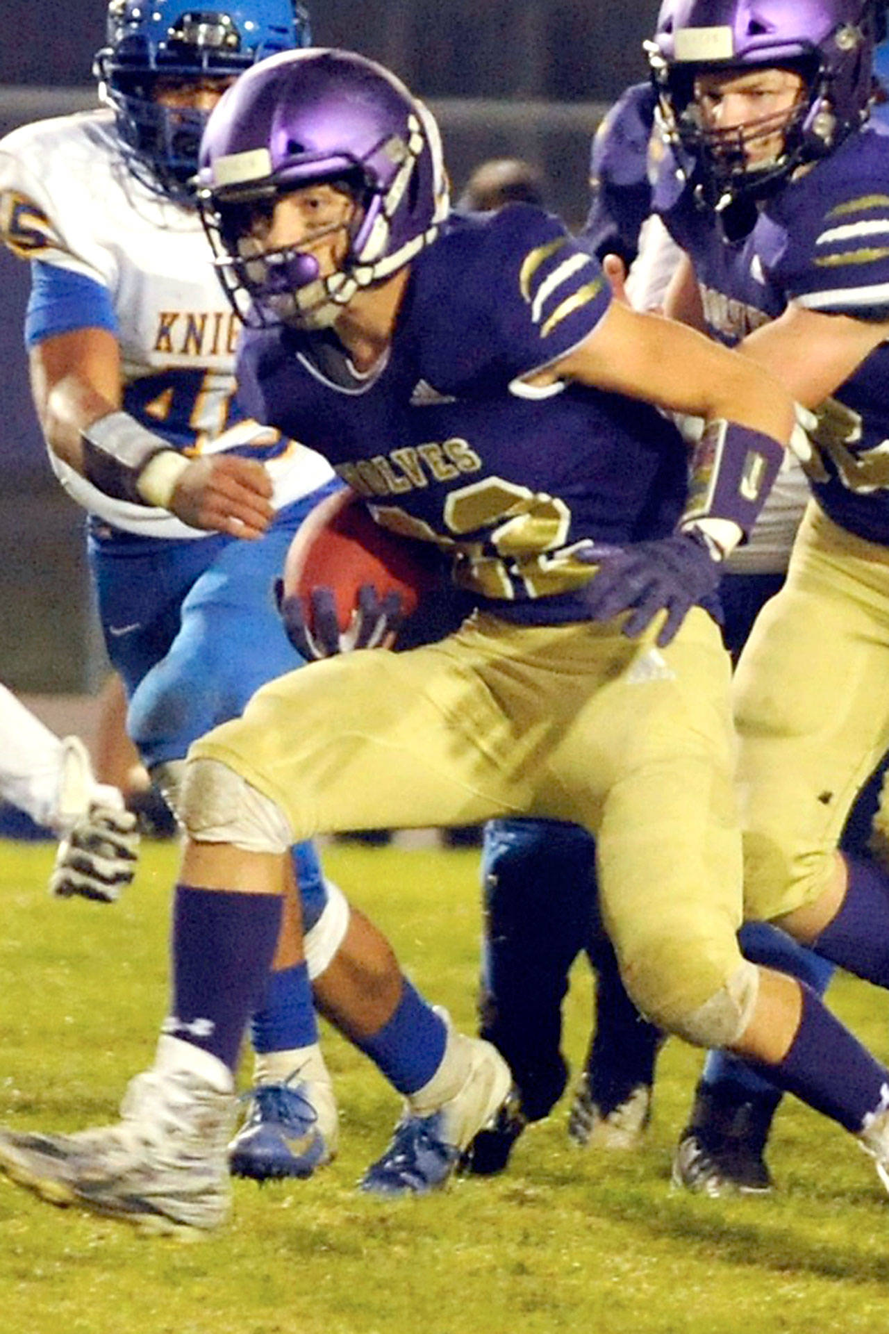 Conor Dowley/Olympic Peninsula News Group Walker Ward breaks through the line during the third quarter of the Sequim Wolves 36-21 win over the Bremerton Knights on Nov. 1. Ward was a reliable workhorse on the night, with 122 yards on 24 carries, and picking up several big first downs to keep drives moving.