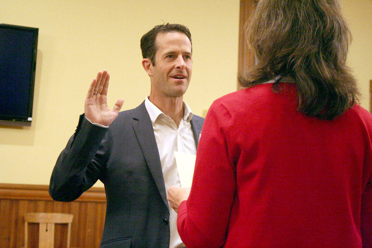 John Mauro, 44, is sworn in as Port Townsend city manager Monday, reciting the oath of office as stated by City Clerk Joanna Sanders. (Brian McLean/Peninsula Daily News)
