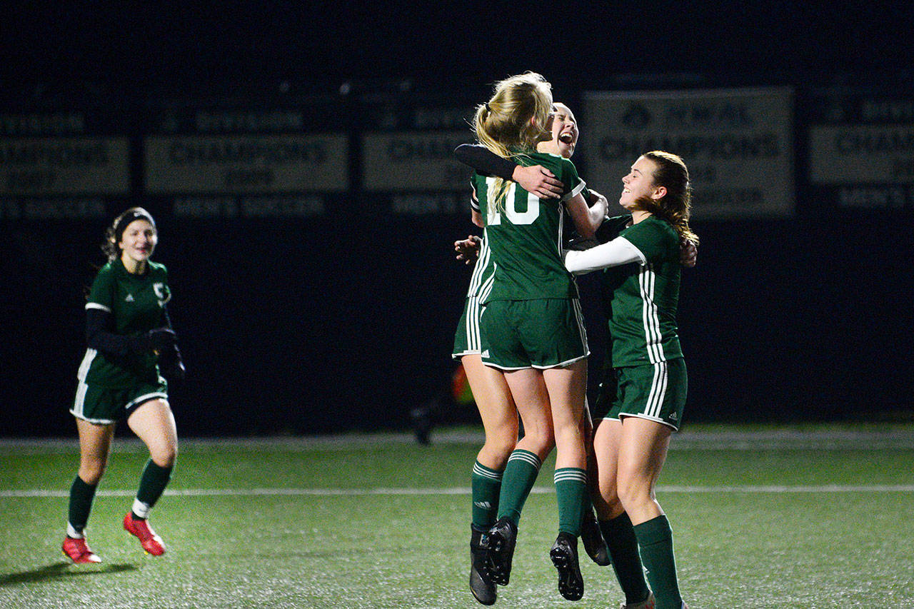Port Angeles Millie Long (10), Hannah Reetz (center) and Bailee Larson celebrate scoring a goal against the Steilacoom Sentinels during a district playoff game at Peninsula College on Tuesday. (Jesse Major/Peninsula Daily News)