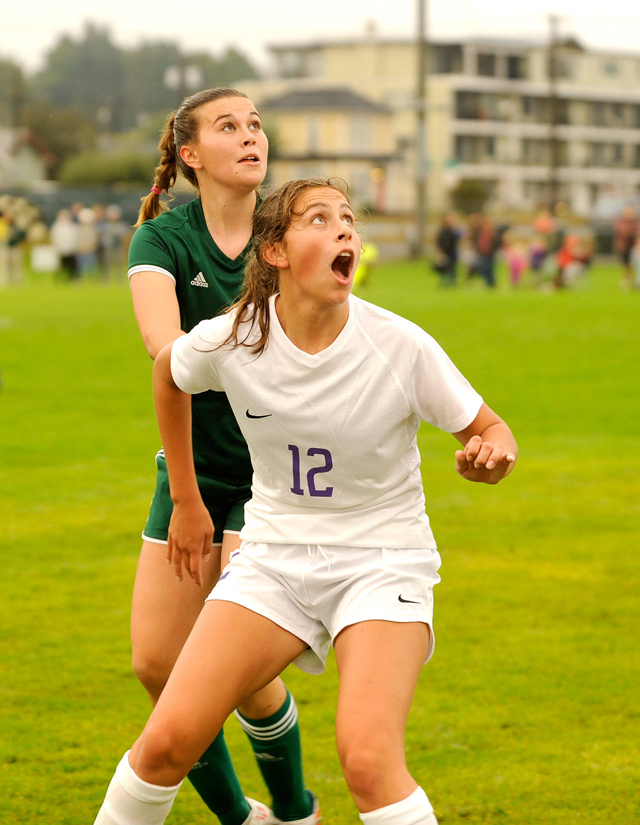 Michael Dashiell/Olympic Peninsula News Group Port Angeles’ Bailee Larson, back, and Sequim’s Jessica Dietzman eye an incoming ball during a September match. The two squads will face off Saturday at Peninsula College with a home state playoff contest on the line.