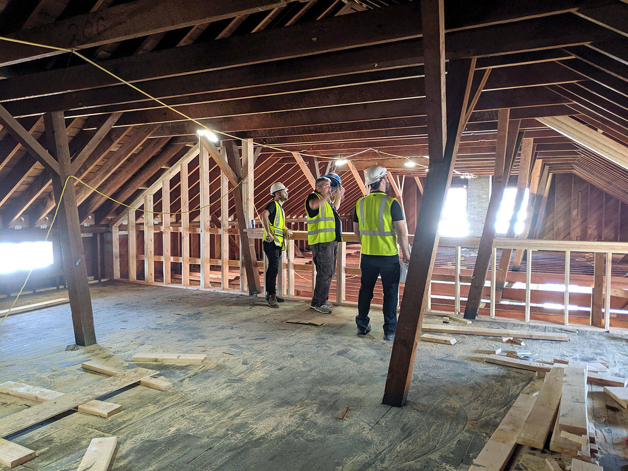 Clark Construction Group employees are seen in the attic of Building 305 at Fort Worden, which is currently being renovated as part of the Makers Square project. (Clark Construction Group)