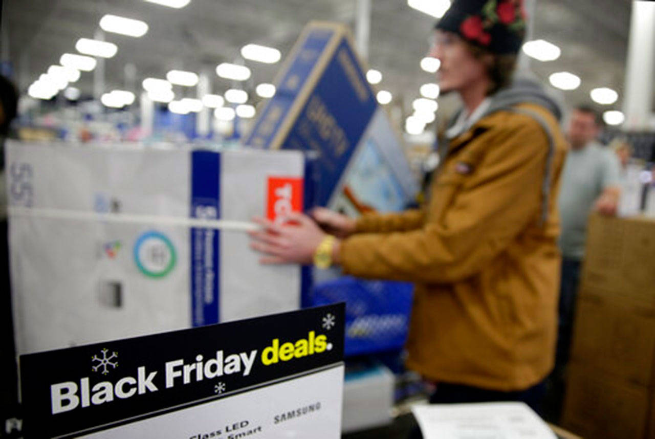 People wait in line to buy televisions as they shop during an early Black Friday sale at a Best Buy store on Thanksgiving Day 2018 in Overland Park, Kan. Black Friday is Nov. 29 this year, but it might as well be the whole month of November. (Charlie Riedel/The Associated Press)