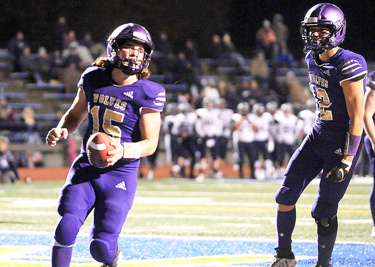 Sequim’s Taig Wiker (15) celebrates after scoring a touchdown in the Wolves’ 37-21 West Central District III 2A district playoff win over River Ridge. (Conor Dowley/Olympic Peninsula News Group)