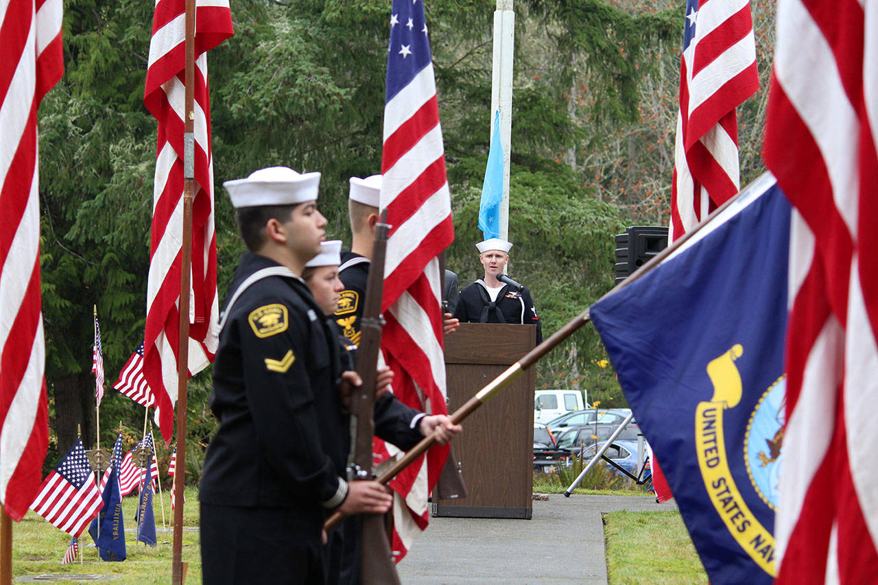 Navy Band Northwest musician Brenton Mitchell sings the national anthem during the honor ceremony for Petty Officer Marvin G. Shields at the Gardiner Cemetery on Monday morning. (Zach Jablonski/Peninsula Daily News)