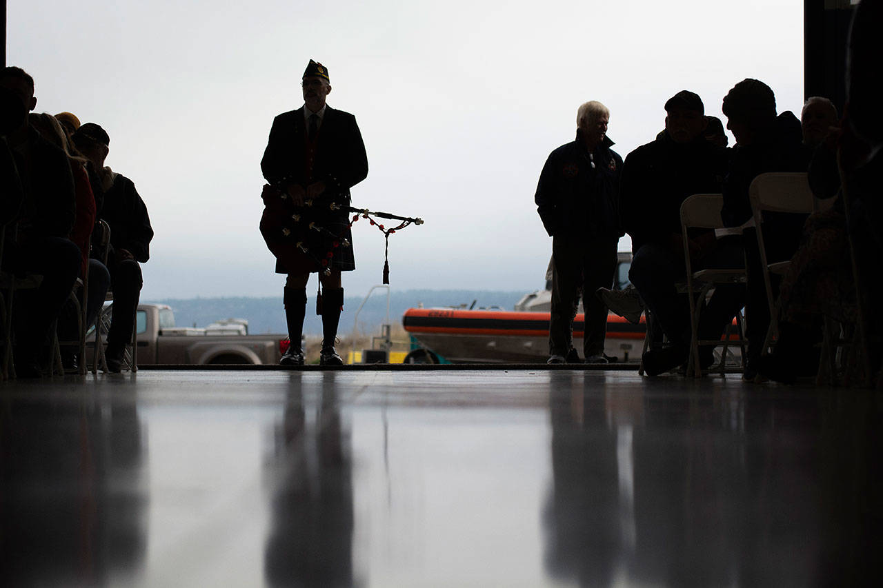 Retired Coastguardsman Rick McKenzie prepares to play bagpipes during the Veterans Day ceremony at U.S. Coast Guard Air Station/Sector Field Office Port Angeles on Monday. (Jesse Major/Peninsula Daily News)