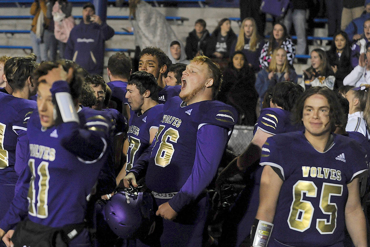 Sequim Wolves players celebrate with fans after their 37-21 district playoff win over the River Ridge Hawks on Nov. 8 to qualify for the Class 2A State Football Tournament for the second year in a row. (Conor Dowley/Olympic Peninsula News Group)